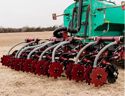 A manure injector with liquid tank. 