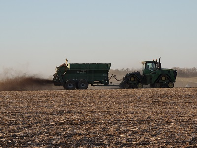 Spinner-style manure spreader in use