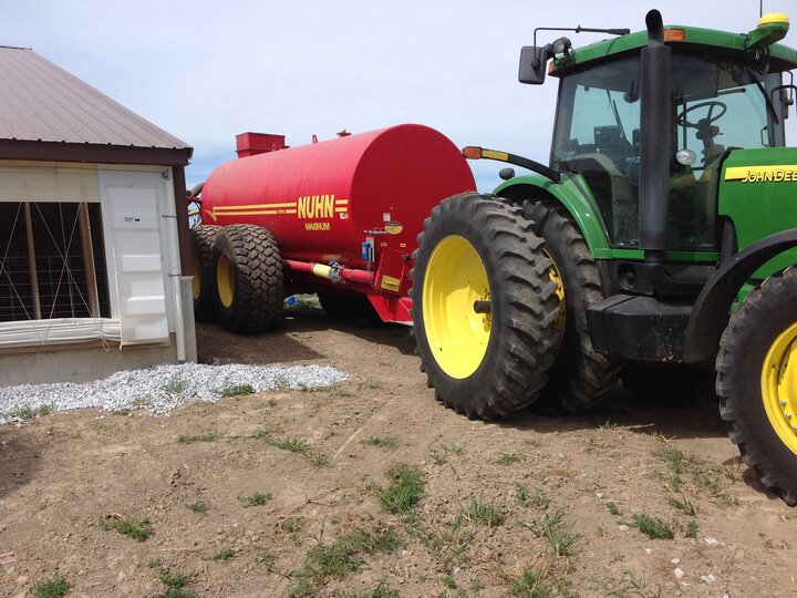 tractor hauling manure in tank