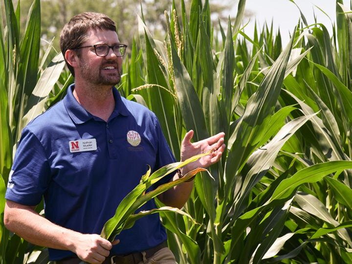 Nathan Mueller speaking in corn field