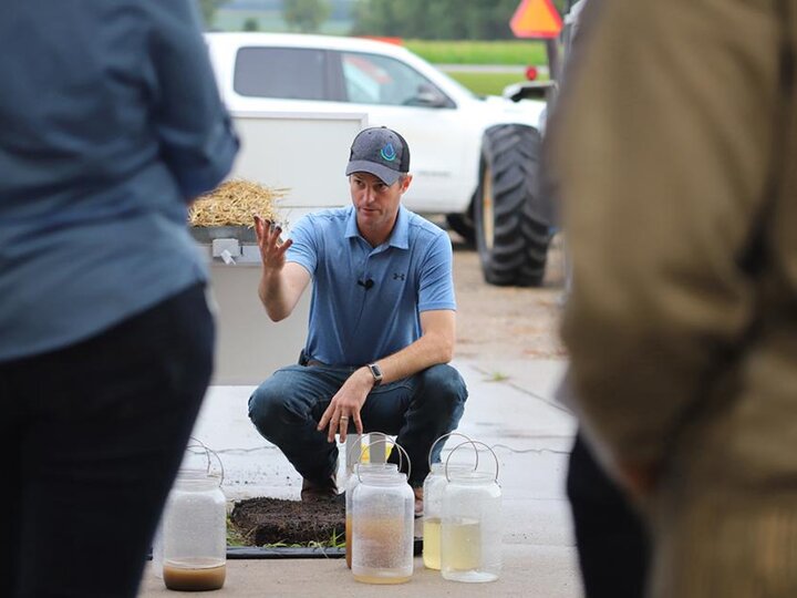 Aaron Hird demonstrates impact of rainfall on different systems using a rainfall simulator