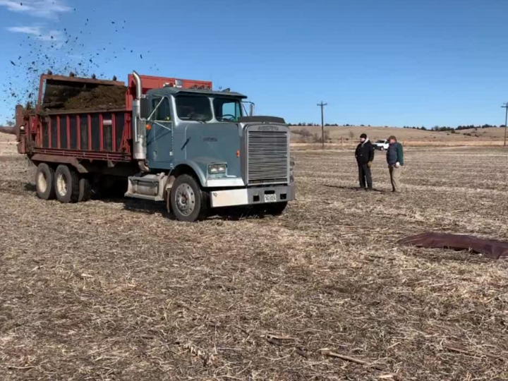 truck mounted spreader going over tarps to calibrate