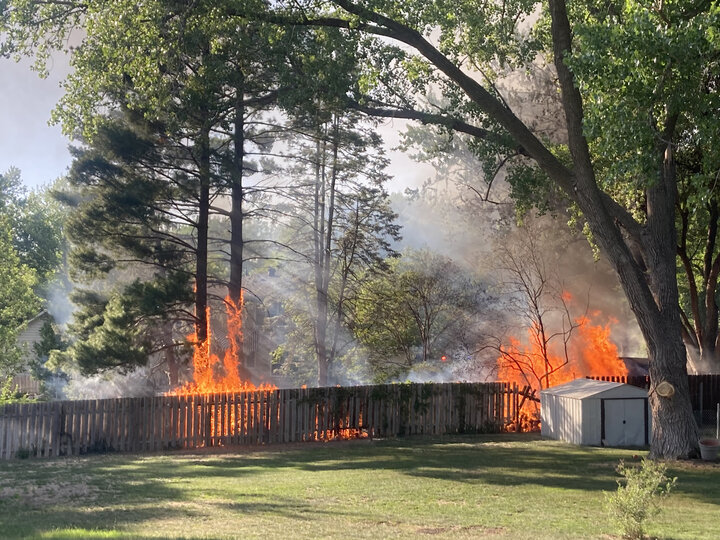 Fire on a fence in a neighborhood. Image courtesy of Sarah Browning