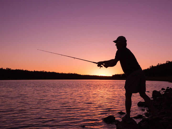 Man fishing at sunset.