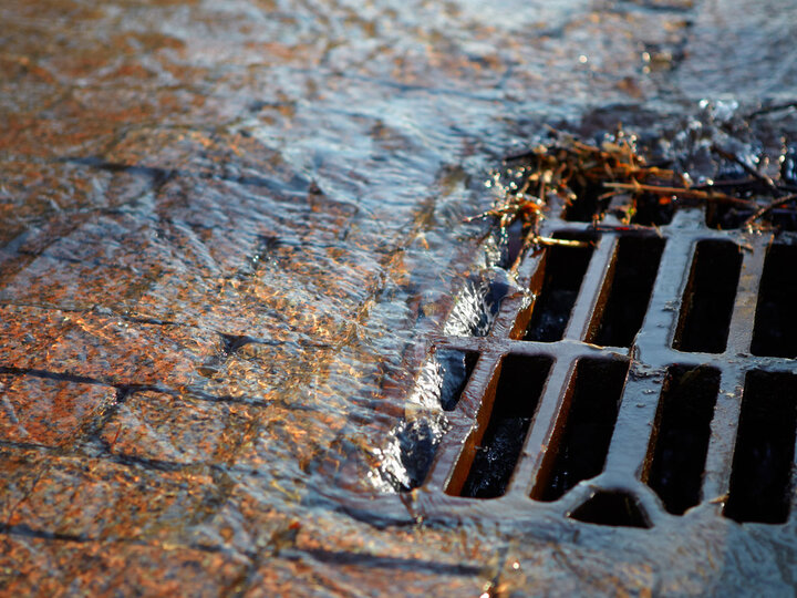 Water flowing into a grate.