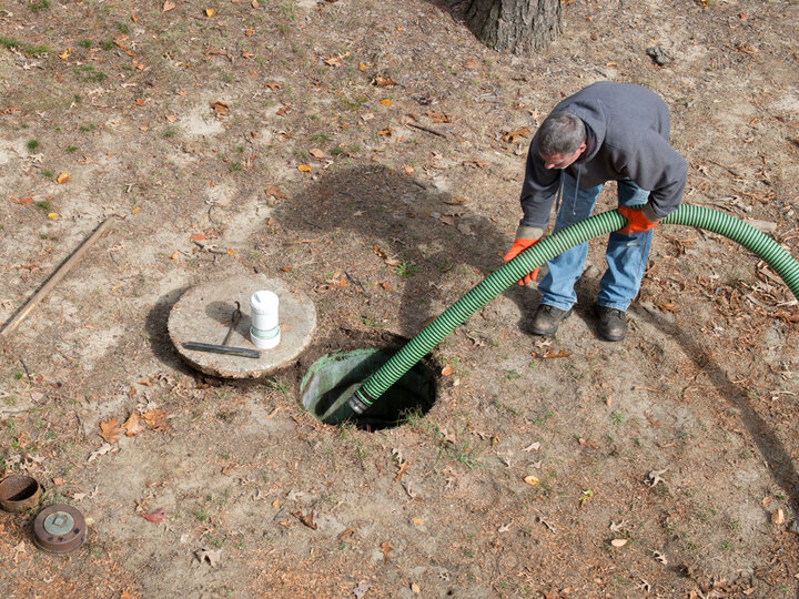 Man pumping a septic tank.