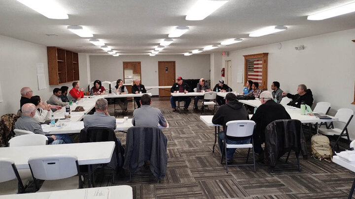 Meeting participants seated in a U-shaped table arrangement during the Shell Creek Watershed workshop, discussing conservation successes and future research needs