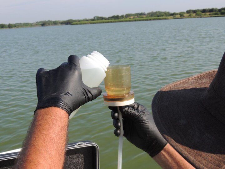 person collecting water sample