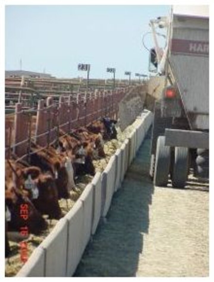 feed truck unloading at feedlot