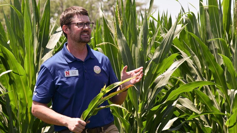 Nathan Mueller speaking in corn field