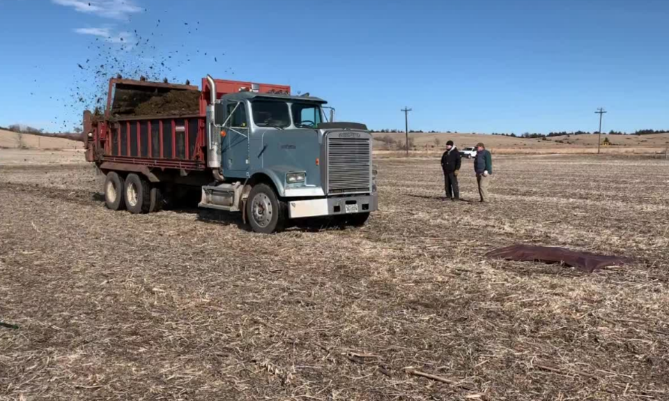 truck mounted spreader going over tarps to calibrate