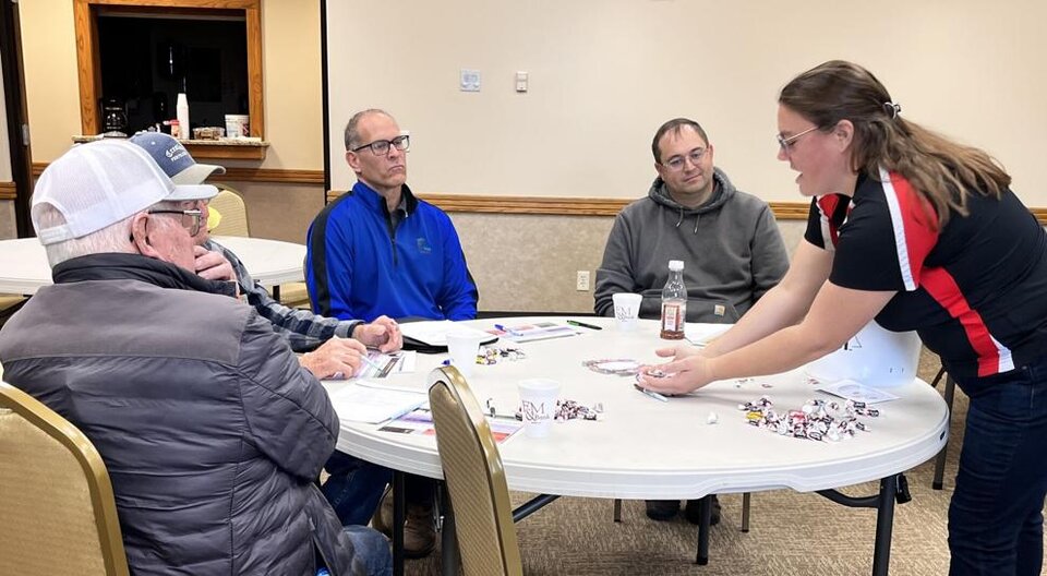  Leslie Johnson uses a mixture of candy to demonstrate the importance of collecting a good representative manure sample at the âSaving Money by Using Manureâ workshop in West Point, Neb. Photo credit: Midwest Messenger