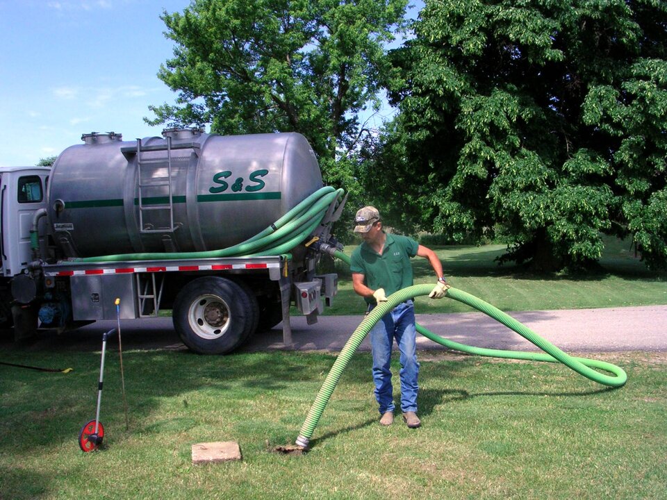 man emptying septic tank